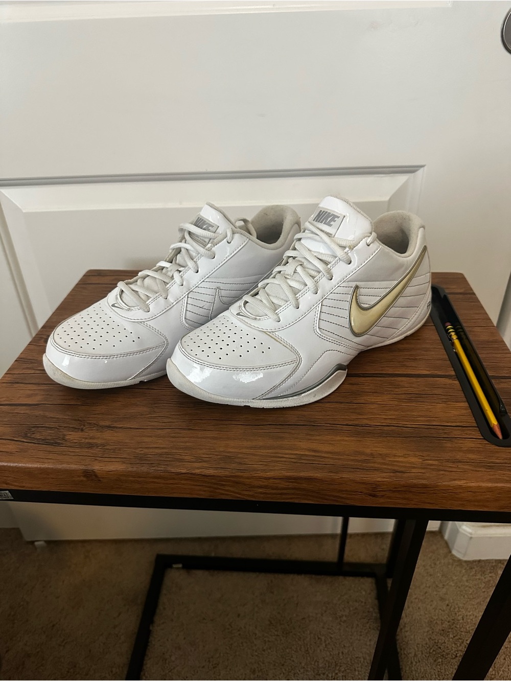 Nike Air White Sneakers with Gold Swoosh Accent